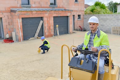 construction worker driving steamroller
